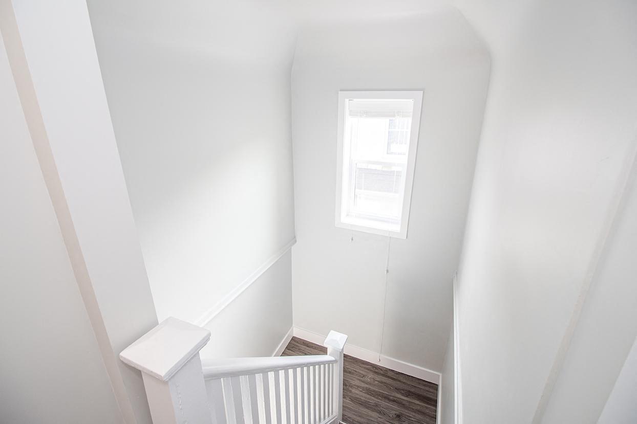 a small white room with a small window